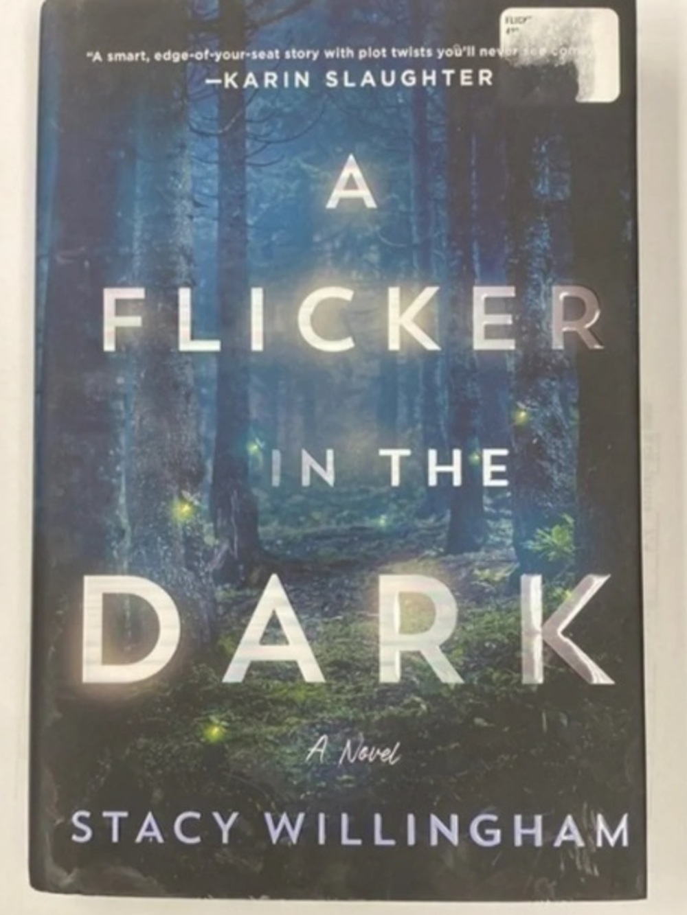 A Flicker in the Dark by Stacy Willingham - Dark Blue Hardcover Novel